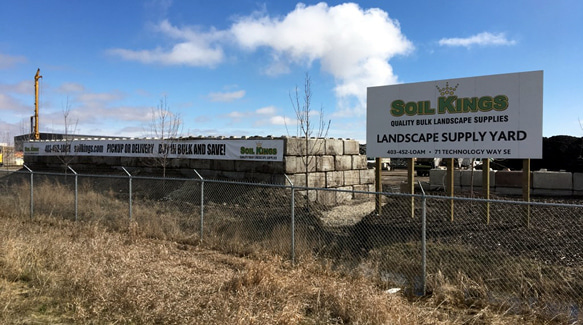 Soil Kings landscape supply yard with signage for bulk soil, gravel, and material pickup.