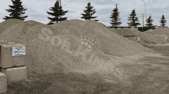 Large pile of crushed gravel for landscaping and construction use at supply yard.
