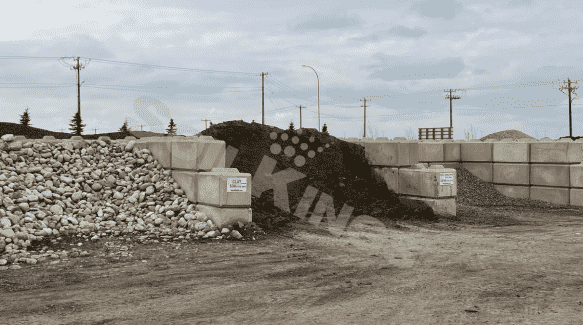 Bulk gravel and black mulch piles at landscape supply yard, offering landscaping materials for construction and outdoor projects.