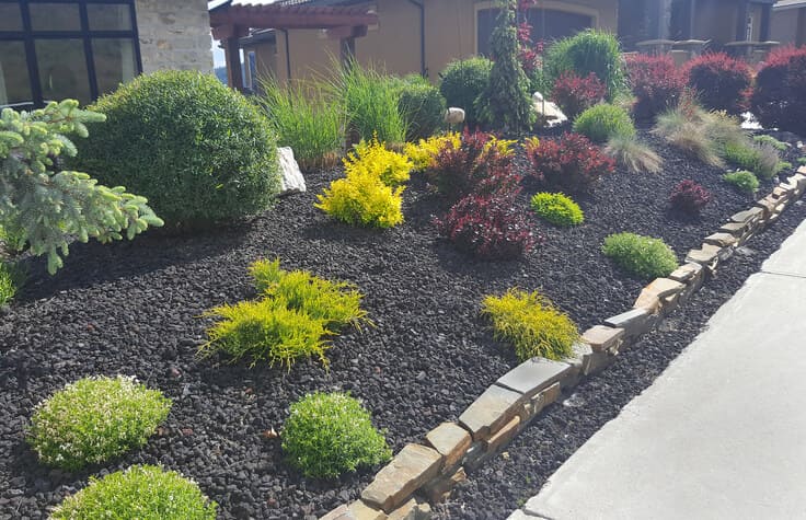 In the comparison of limestone and rundle rock, rundle rock is used as decorative mulch in the garden to enhance its vibrant appearance.