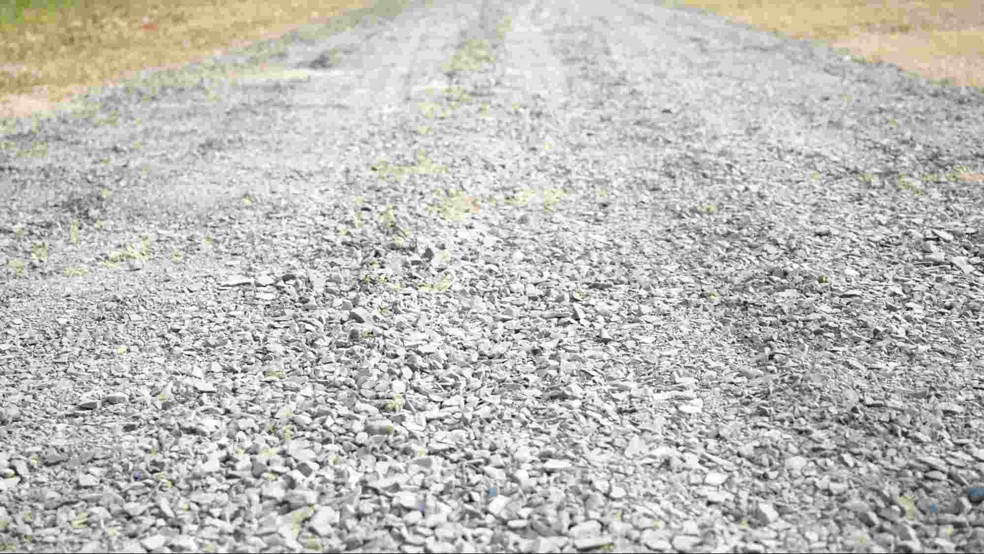 Crushed limestone fines compacted into a durable gravel driveway surface, demonstrating the strength, stability, and drainage benefits of crushed limestone fines for residential and rural access roads.